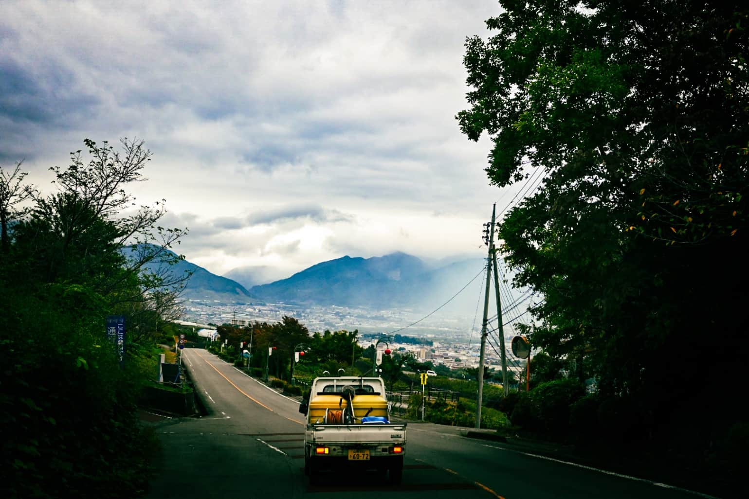 White Kei Truck Driving on a Scenic Rural Mountain Road